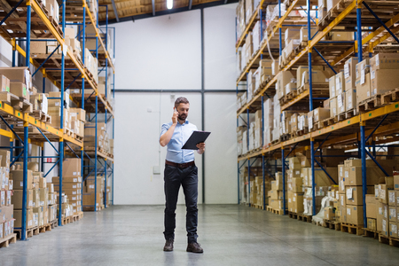 Worker in warehouse looking at tablet