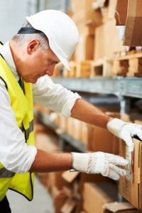 Male Warehouse Worker Counting Inventory 
