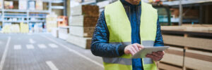 Young warehouse worker consulting a tablet