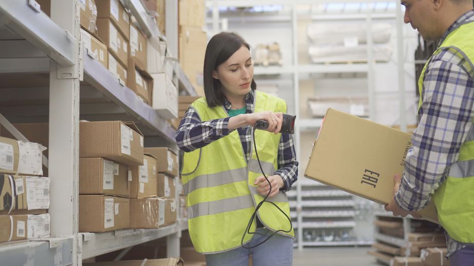 Warehouse worker scans the product barcode scanner