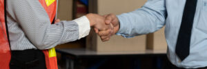 Warehouse worker shaking hands with client