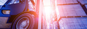 Forklift loader lifting pallets in warehouse