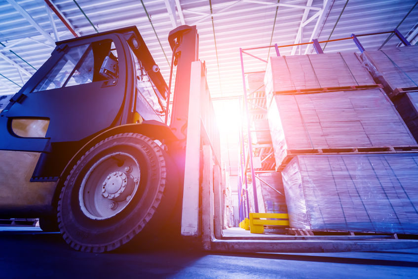 Forklift loader lifting pallets in warehouse