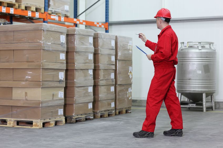 worker counting stocks in a company warehouse