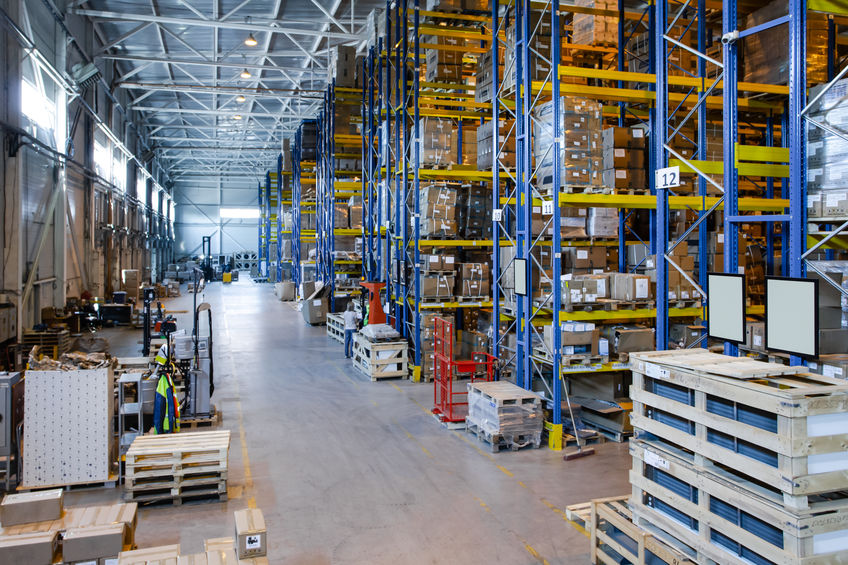 Interior of a modern warehouse storage of retail shop with pallet truck near shelves