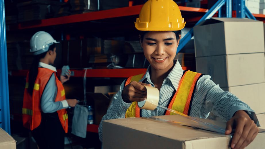 Worker packaging up a box for storage