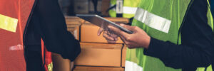 Warehouse workers working together in in pick and pack warehouse.