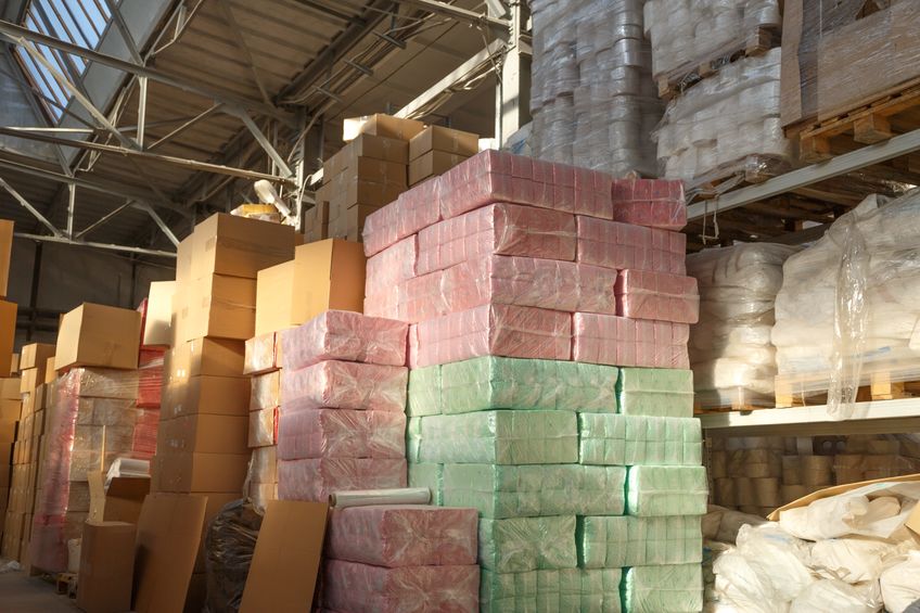 Paper products stacked on warehouse shelf