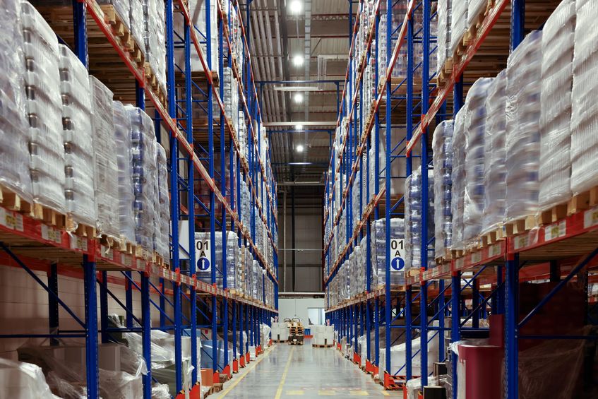 warehouse interior with metal racks full of merchandise.